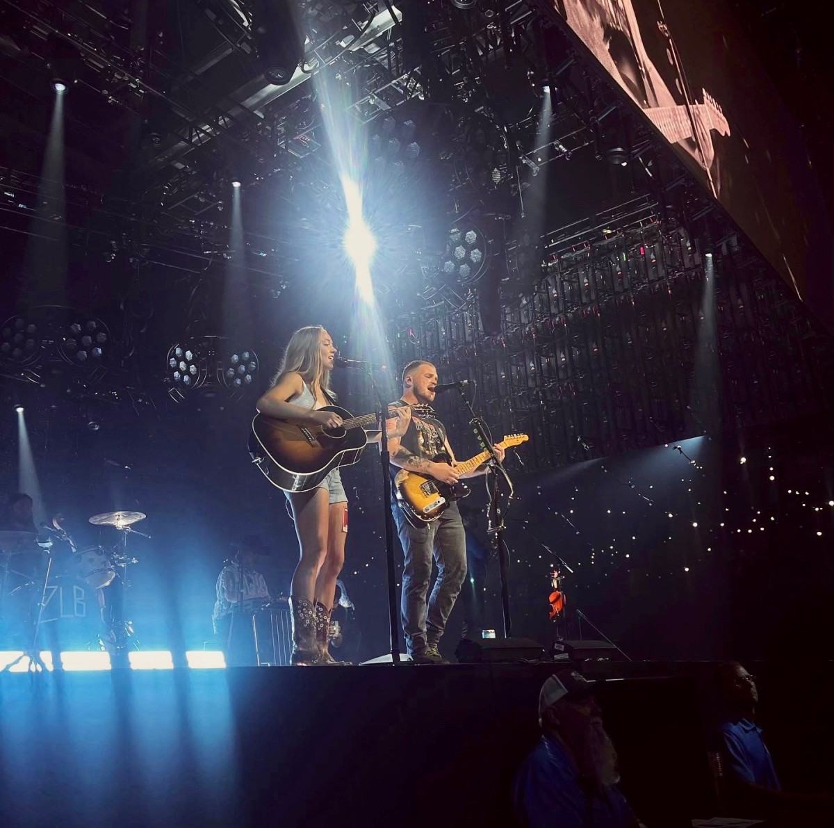Eagle girls basketball player Molly Johnson playing guitar with country music star Zach Bryan